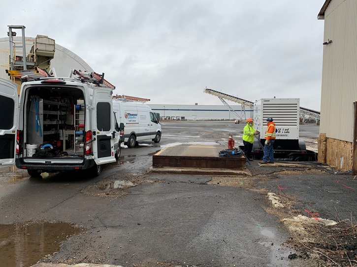 Standby generator installation with professional electrical connections and safety equipment